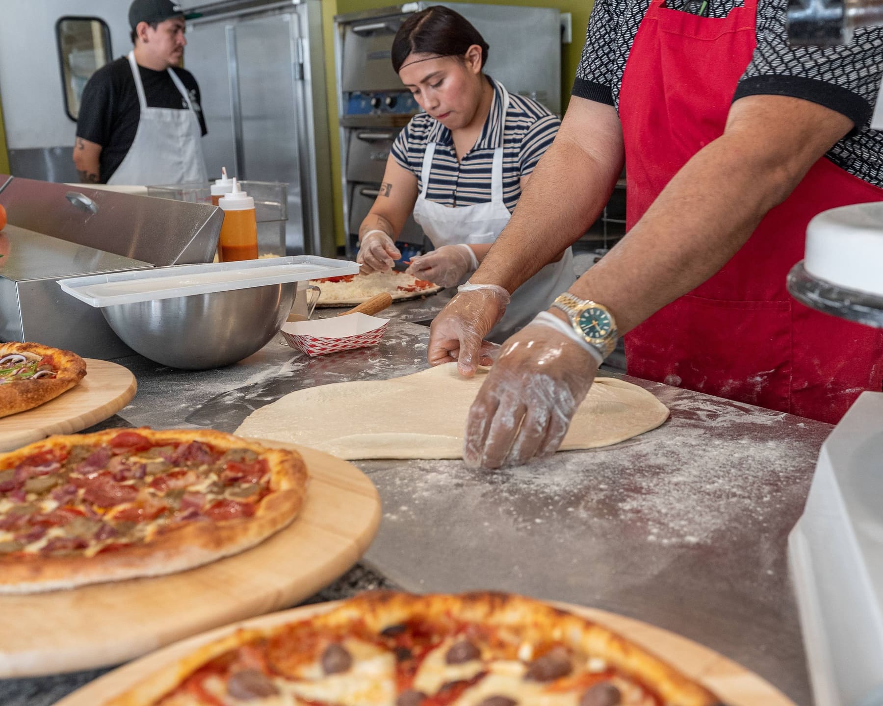 Nino's kitchen team making pizzas